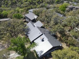 high aerial view of large home with metal roof